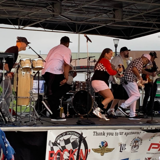 Band performing on stage at Rockin' on Main outdoor event