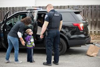 Police officer talking with a little boy