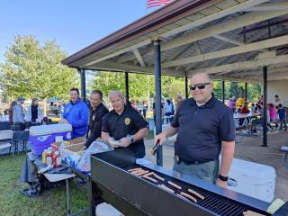 Police offers serving hot dogs at a community event