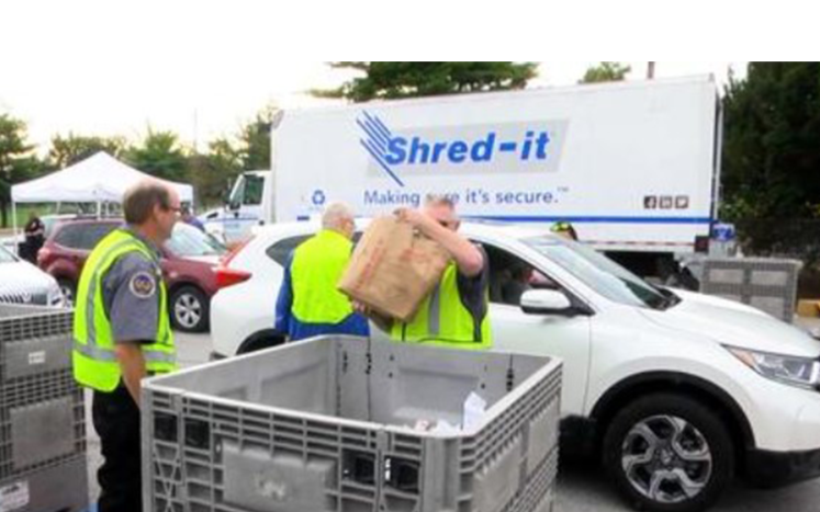 People dropping of boxes for shred-it event